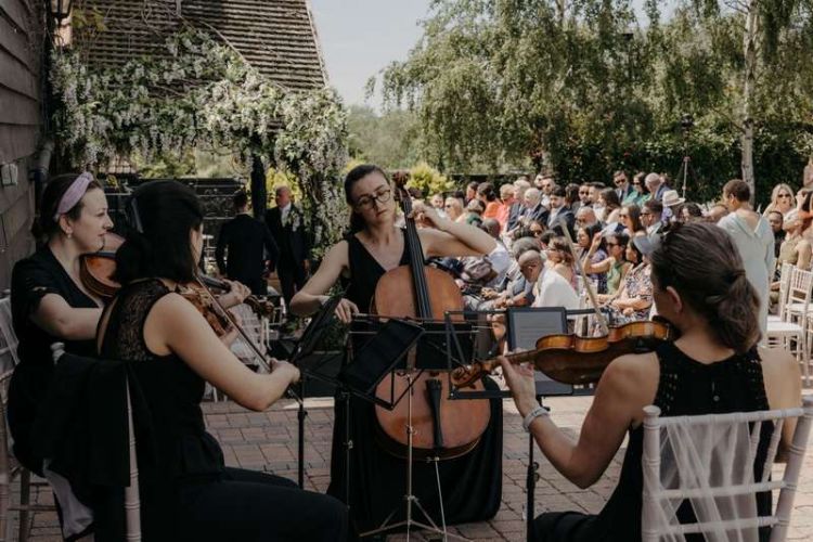 live wedding music at the baronial barn at Crondon Park being played by string quartet.